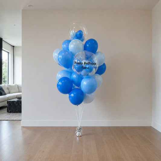 Bouquet of blue and white balloons in a living room setting.