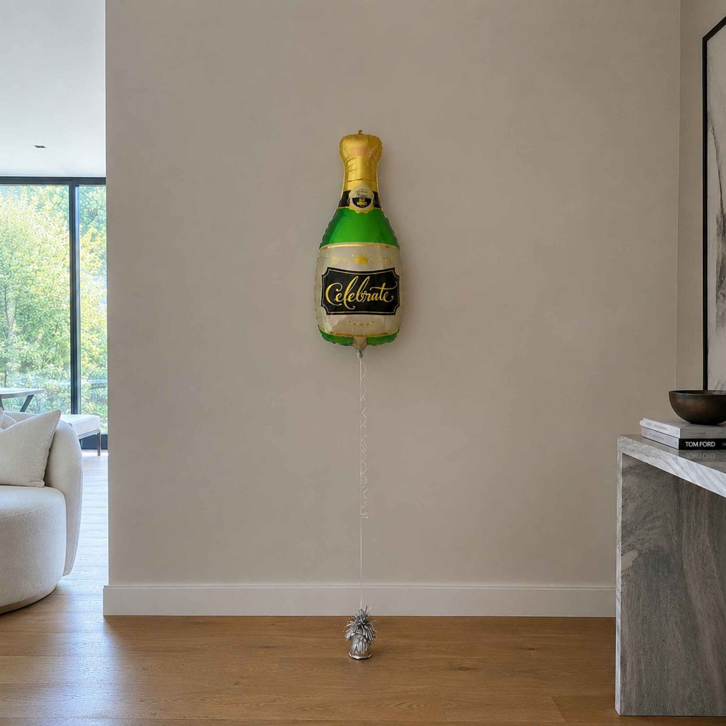 Champagne bottle balloon on a wall in a living room