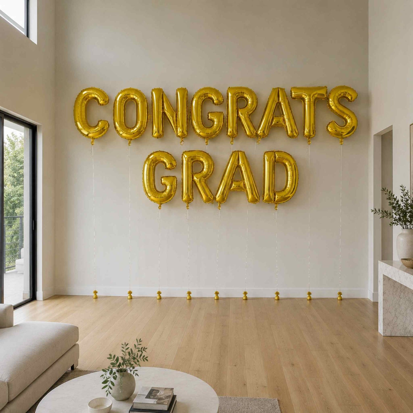 Gold 'CONGRATS GRAD' balloons in a living room setting.