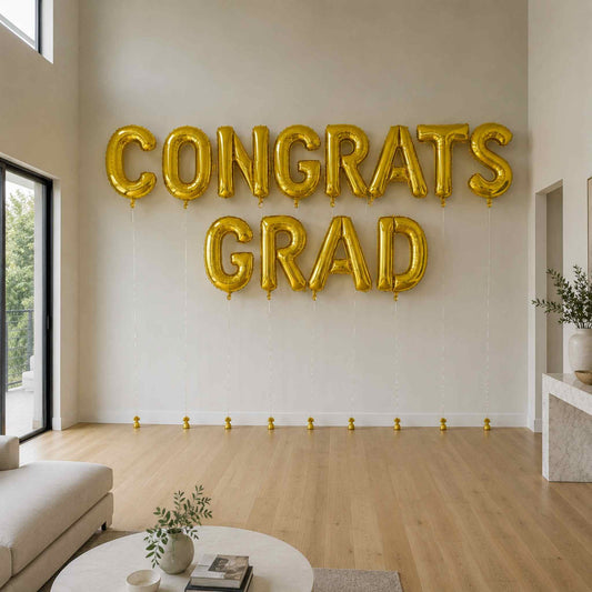 Gold 'CONGRATS GRAD' balloons in a living room setting.
