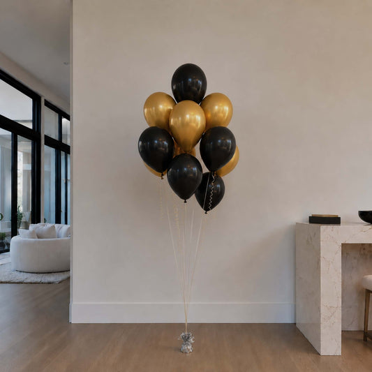 Bouquet of black and gold balloons in a modern living room.