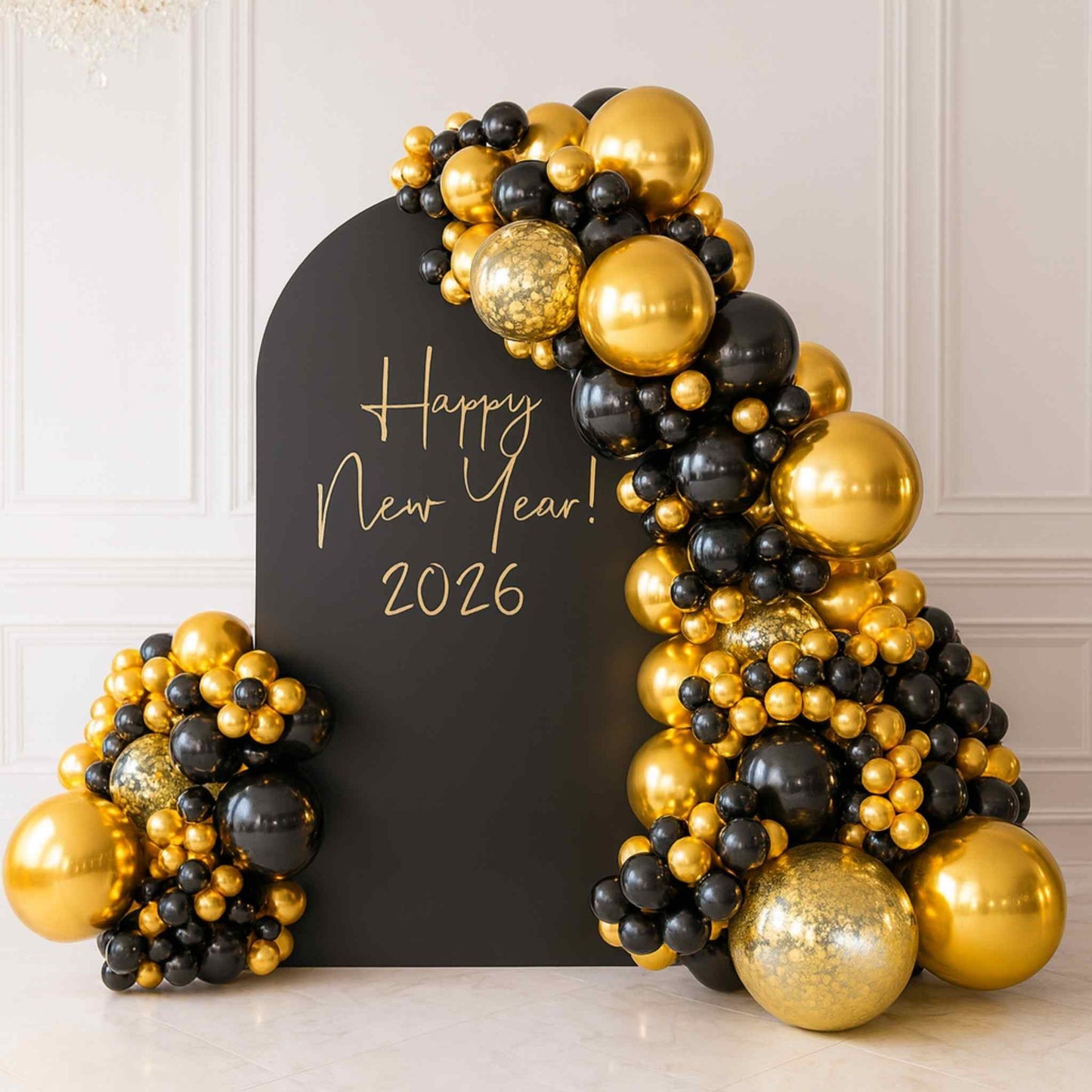 Decorative arch made of gold and black balloons with 'Happy New Year! 2026' sign on a white background