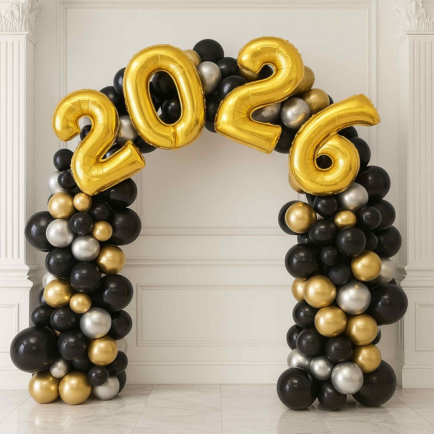 Balloon arch with '2026' numbers in gold, black, and silver on a white wall.