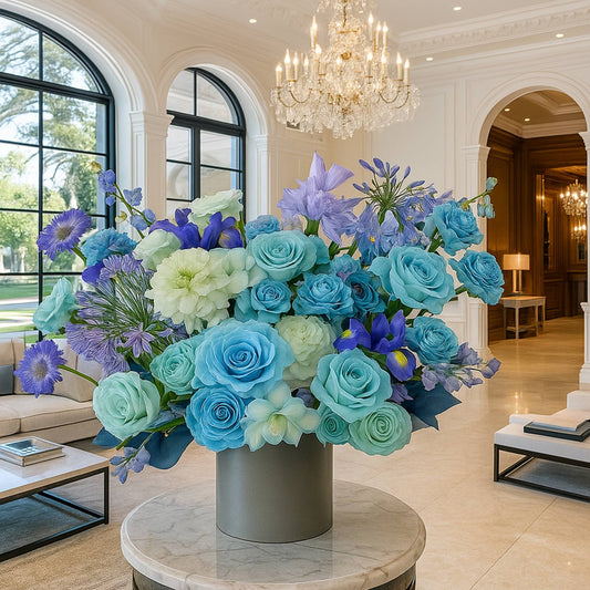 Colorful flower arrangement in a gray vase on a marble table in a luxurious living room.
