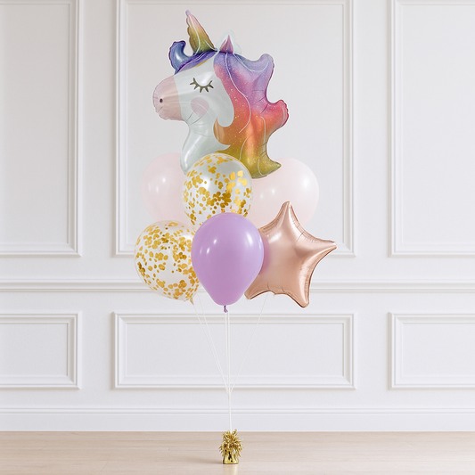 Colorful unicorn-shaped balloon with other balloons against a white paneled wall.
