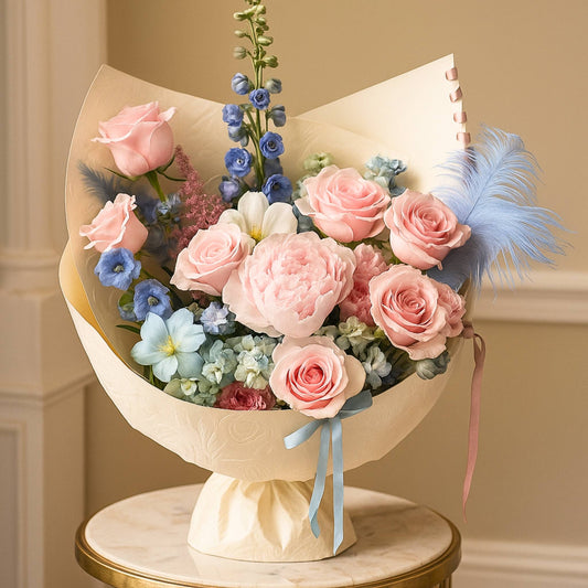 Bouquet of pink and blue flowers with feathers on a beige background