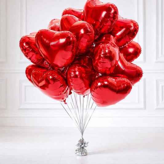 Bouquet of red heart-shaped balloons on a white background