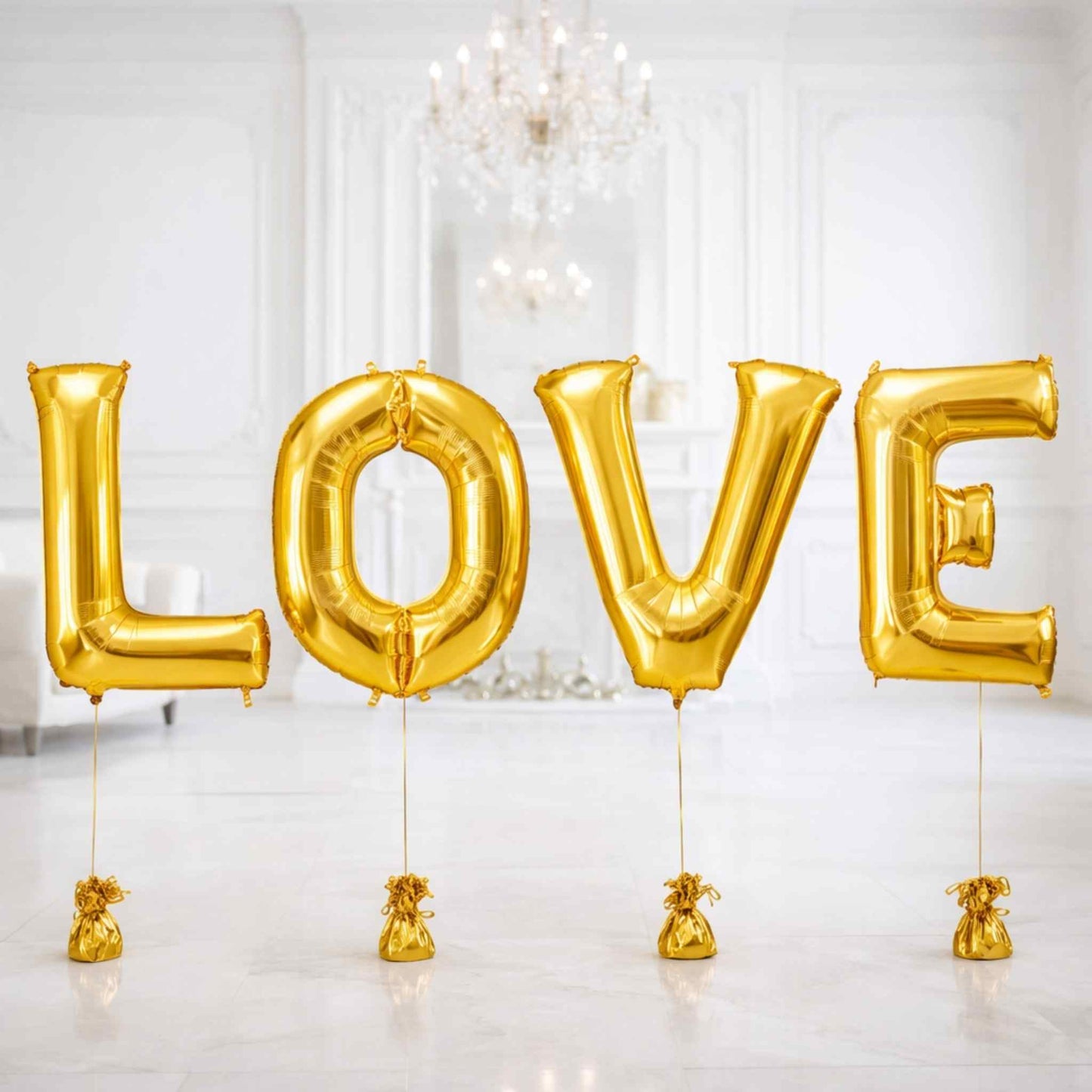 Gold 'LOVE' balloons in a room with chandeliers