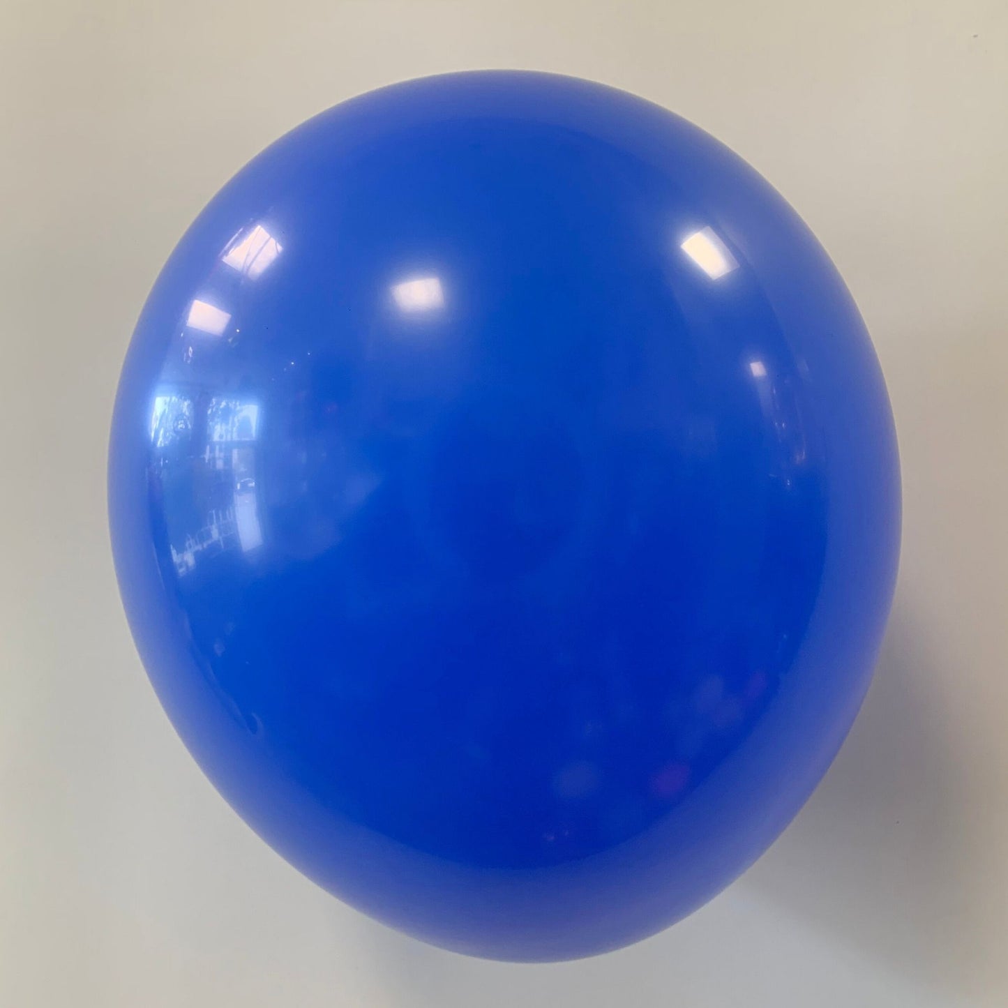 Blue balloon on a light gray background