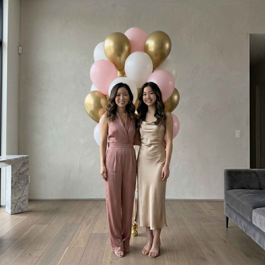 pink, white, and chrome gold balloons in an apartment with woman and daughter standing in front 