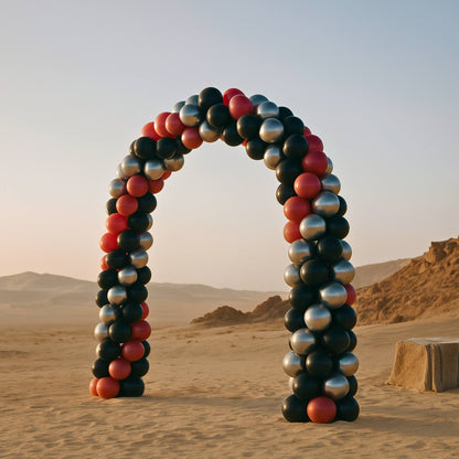 Balloon arch in a desert landscape with mountains in the background