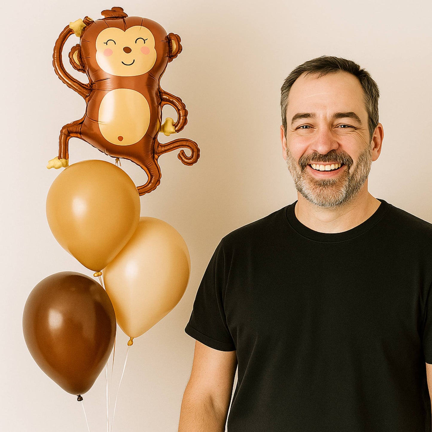 Fathers Day monkey foil balloon bouquet with helium-filled brown, blush, and peach balloons on gold weight.