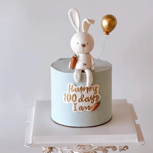 Rabbit holding balloon cake