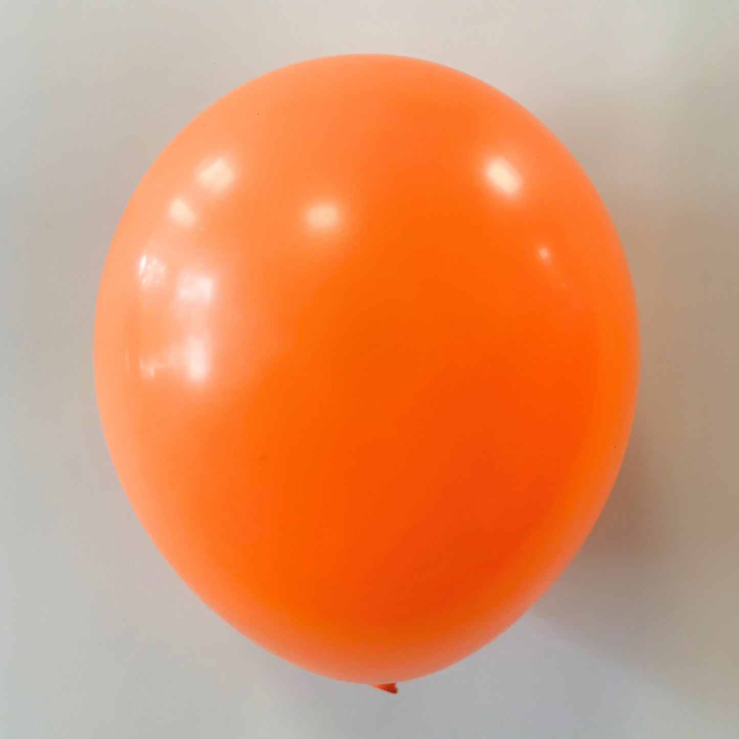 11 inch helium filled Orange latex balloon