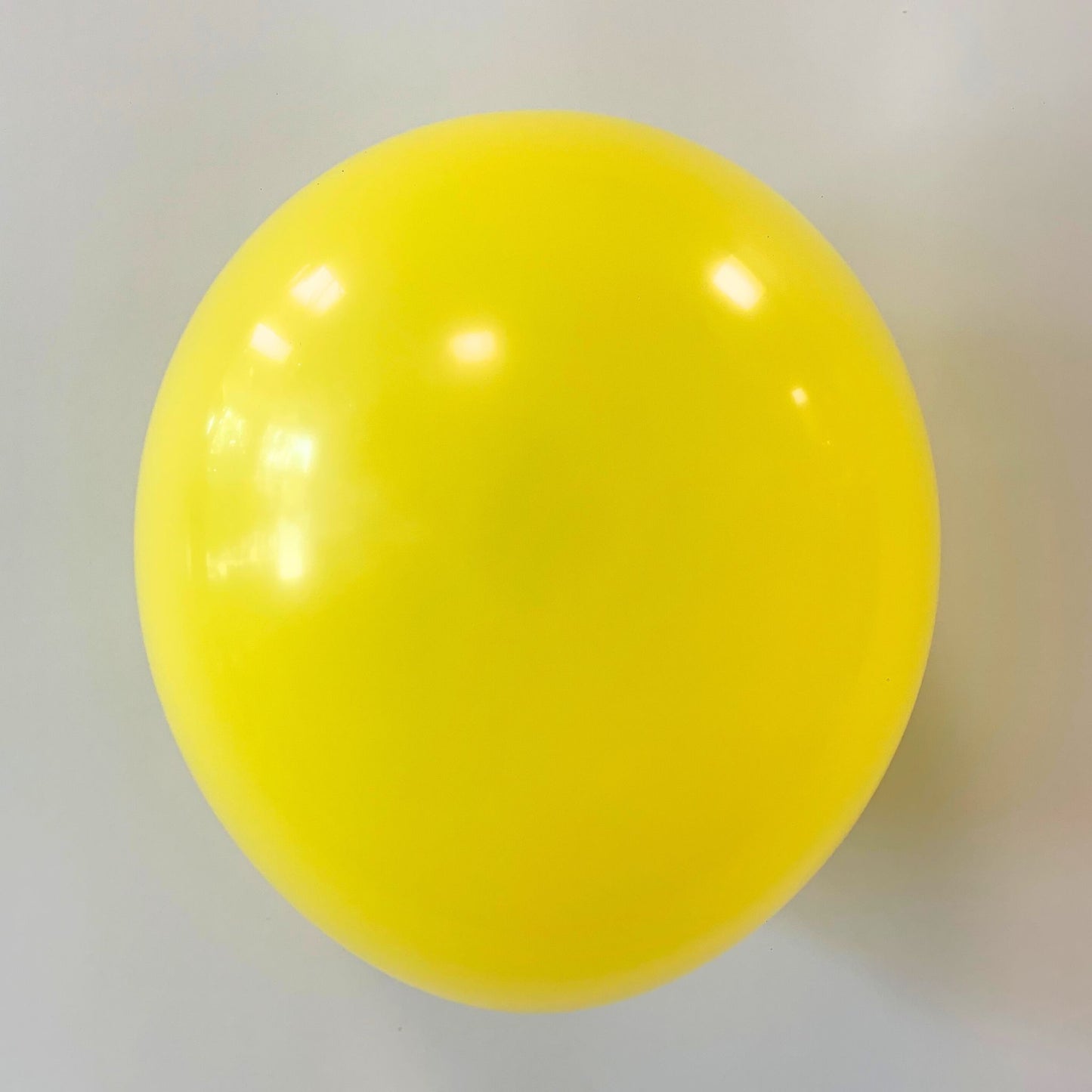 11 inch helium filled yellow latex balloon
