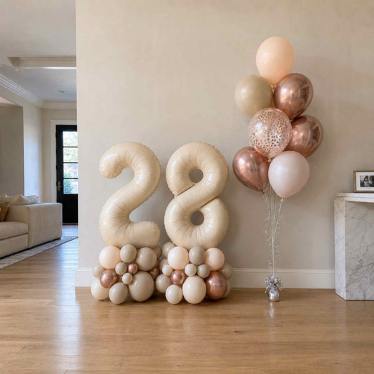 Balloon decorations with the number 28 in a living room setting