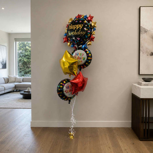 Colorful 'Happy Birthday' balloons in a living room setting.