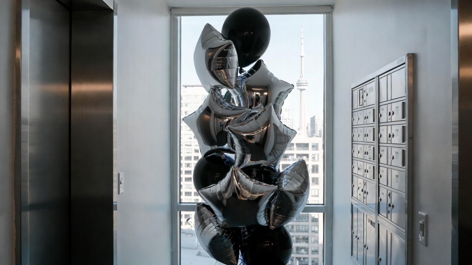 Modern sculpture in an elevator shaft with cityscape view