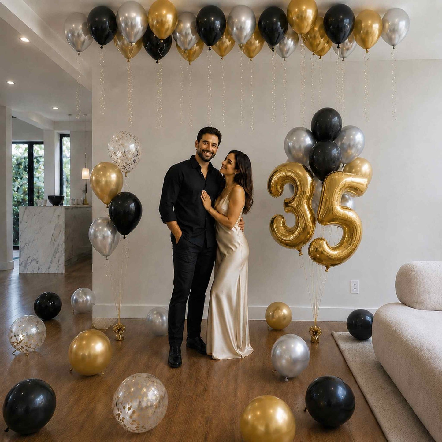 Couple celebrating a 35th birthday with balloons in a modern living room.