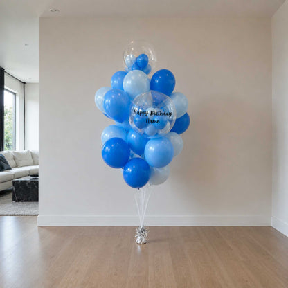 Bouquet of blue and white balloons in a living room setting.