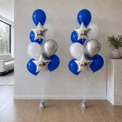 Two sets of blue, silver, and white balloons with star-shaped balloons in a room.
