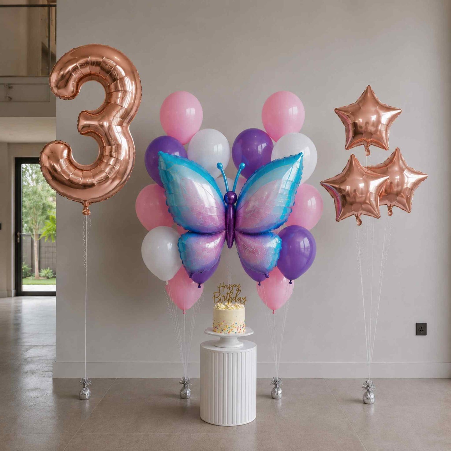 Decorative balloon setup with number '3', butterfly balloon, and stars in a room.