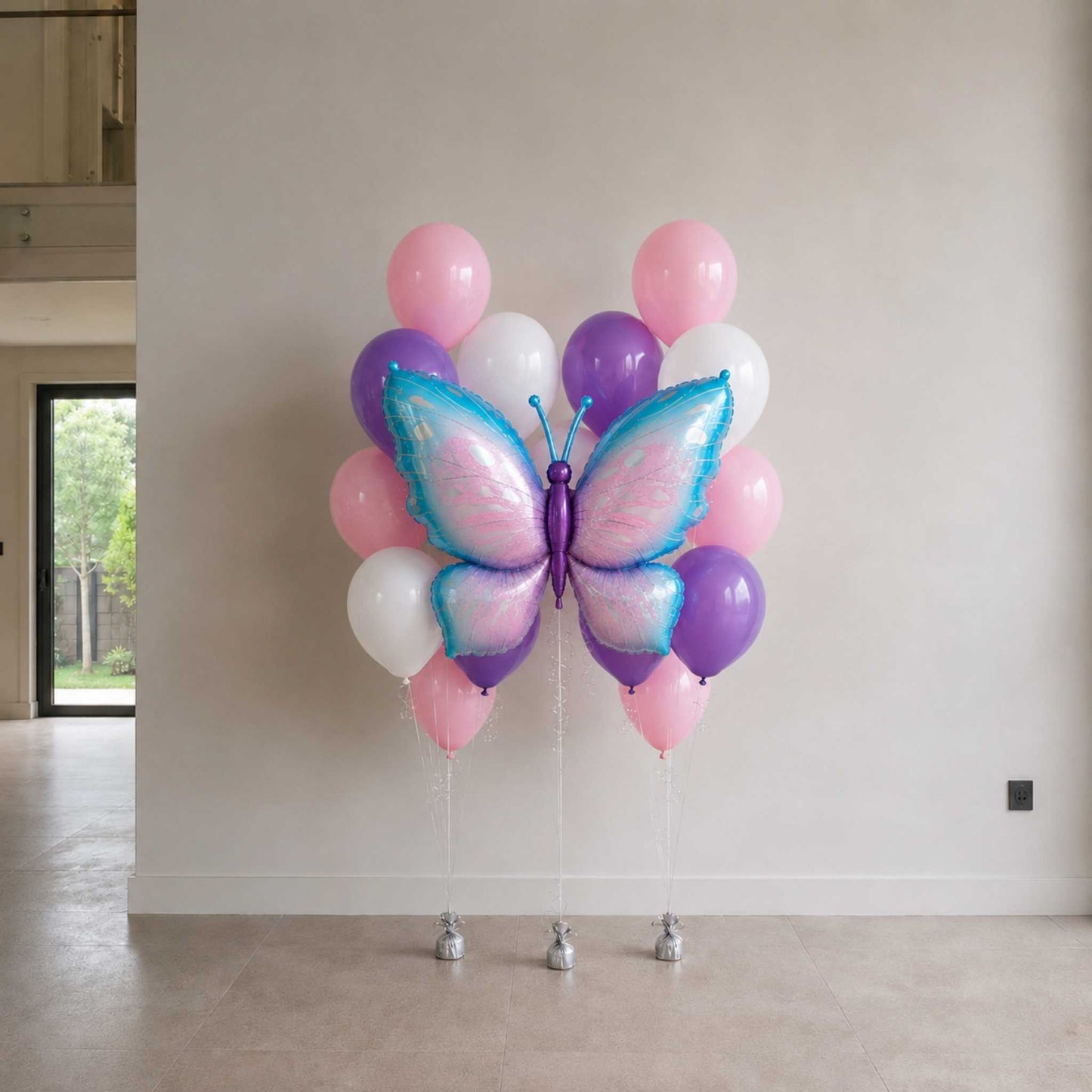 Butterfly-shaped balloon arrangement against a white wall