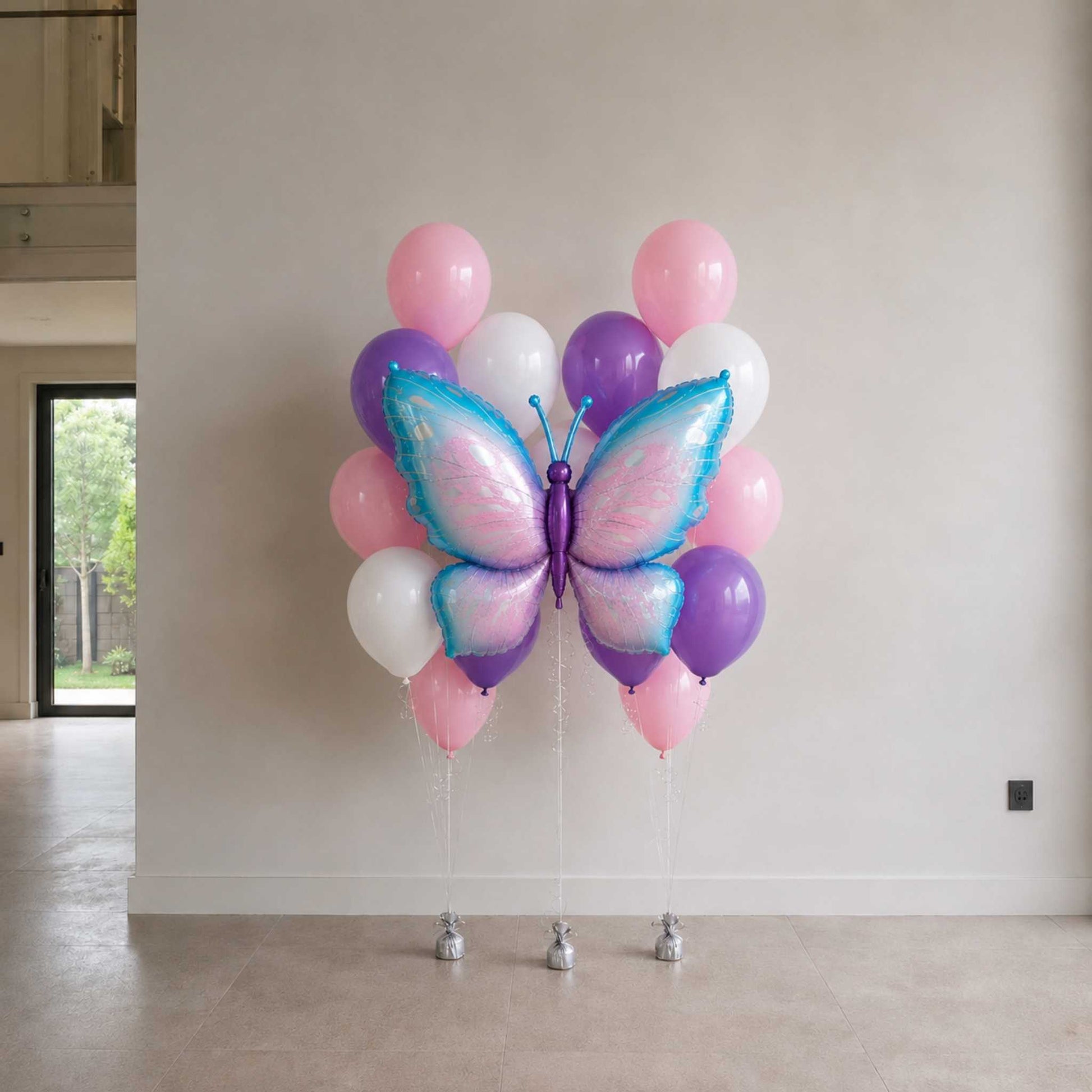Butterfly-shaped balloon arrangement against a white wall