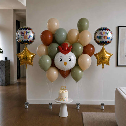Balloon arrangement with a chicken design and 'Happy Birthday' balloons in a living room.