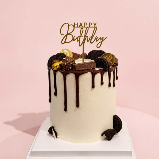 Chocolate drip birthday cake with decorative elements on a pink background