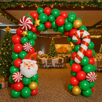 Christmas-themed balloon arch with Santa Claus face in a decorated room.