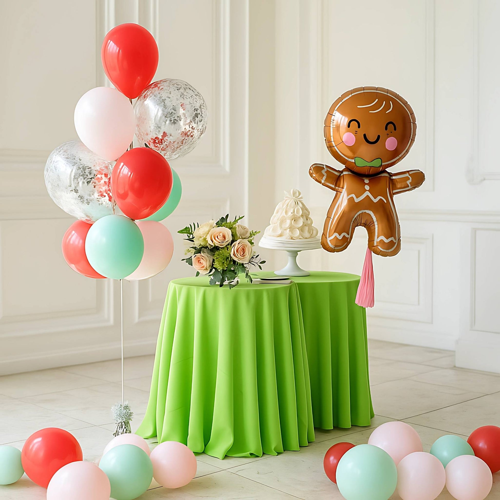 Decorative setup with balloons, a gingerbread man balloon, and a green tablecloth.