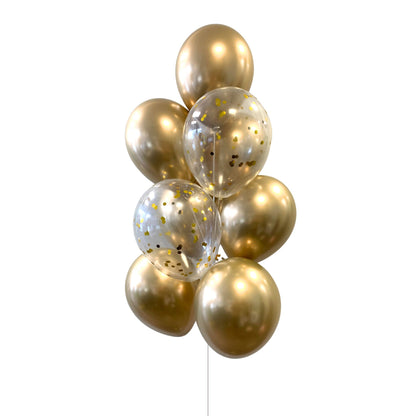 A bouquet of round helium balloons primarily in gold color, with some featuring a shining effect and others clear with gold confetti inside.