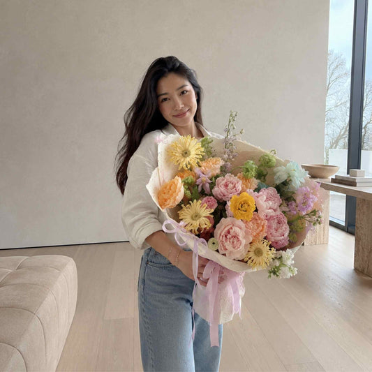 Woman holding a bouquet of flowers indoors