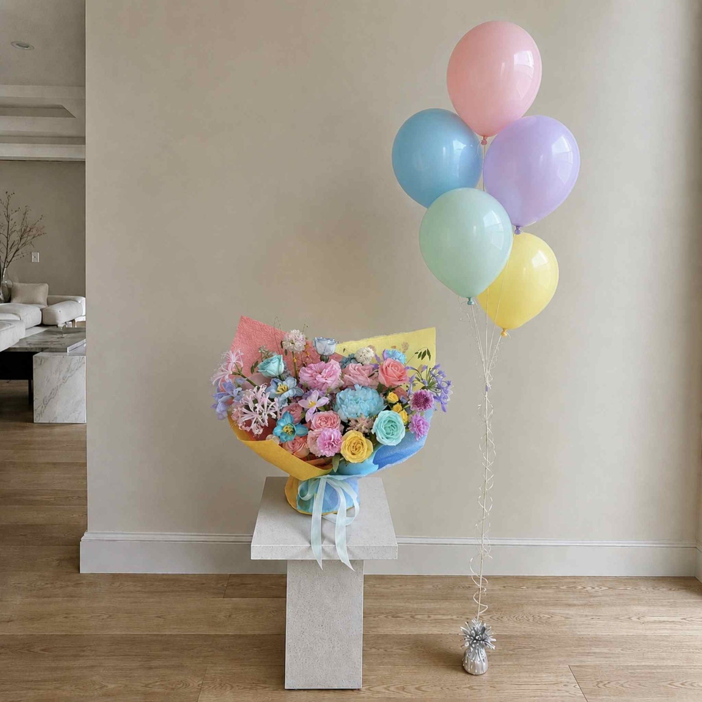 Bouquet of flowers with colorful balloons on a stand in a room.