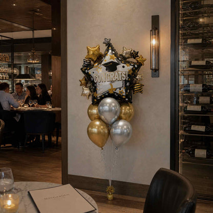 Decorative balloons with 'Congrats!' on a wall in a restaurant setting
