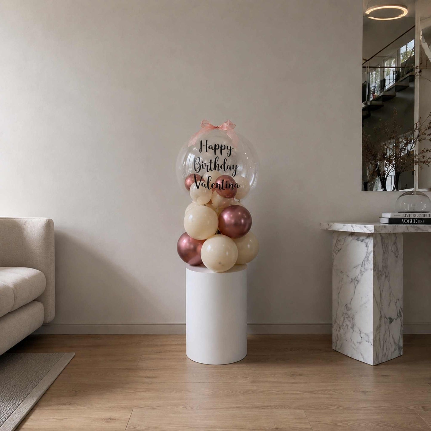 Balloon sculpture with 'Happy Birthday Valentine' text in a living room setting.
