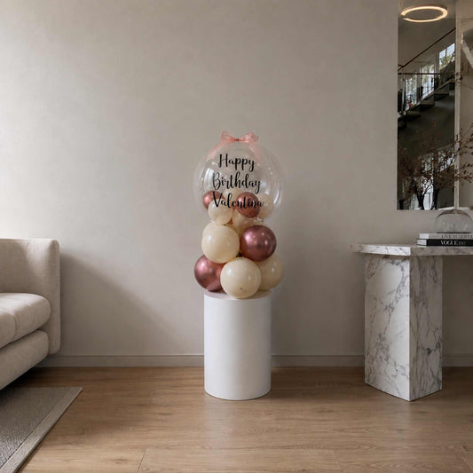 Balloon sculpture with 'Happy Birthday Valentine' text in a living room setting.