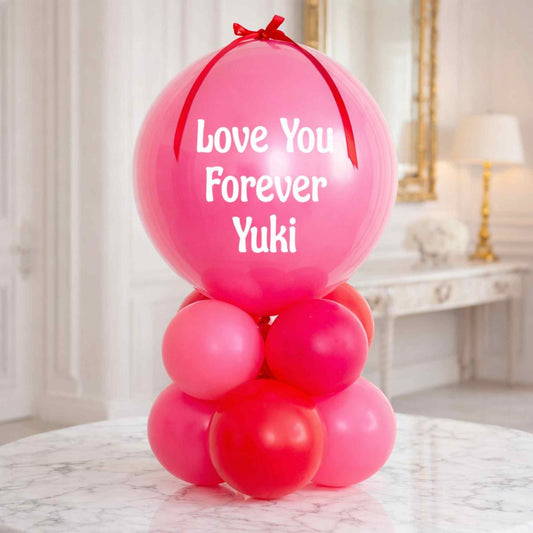 Pink balloons with 'Love You Forever Yuki' text in a decorative setting.