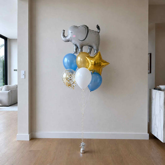 Balloon bouquet with elephant, stars, and colorful balloons in a room.