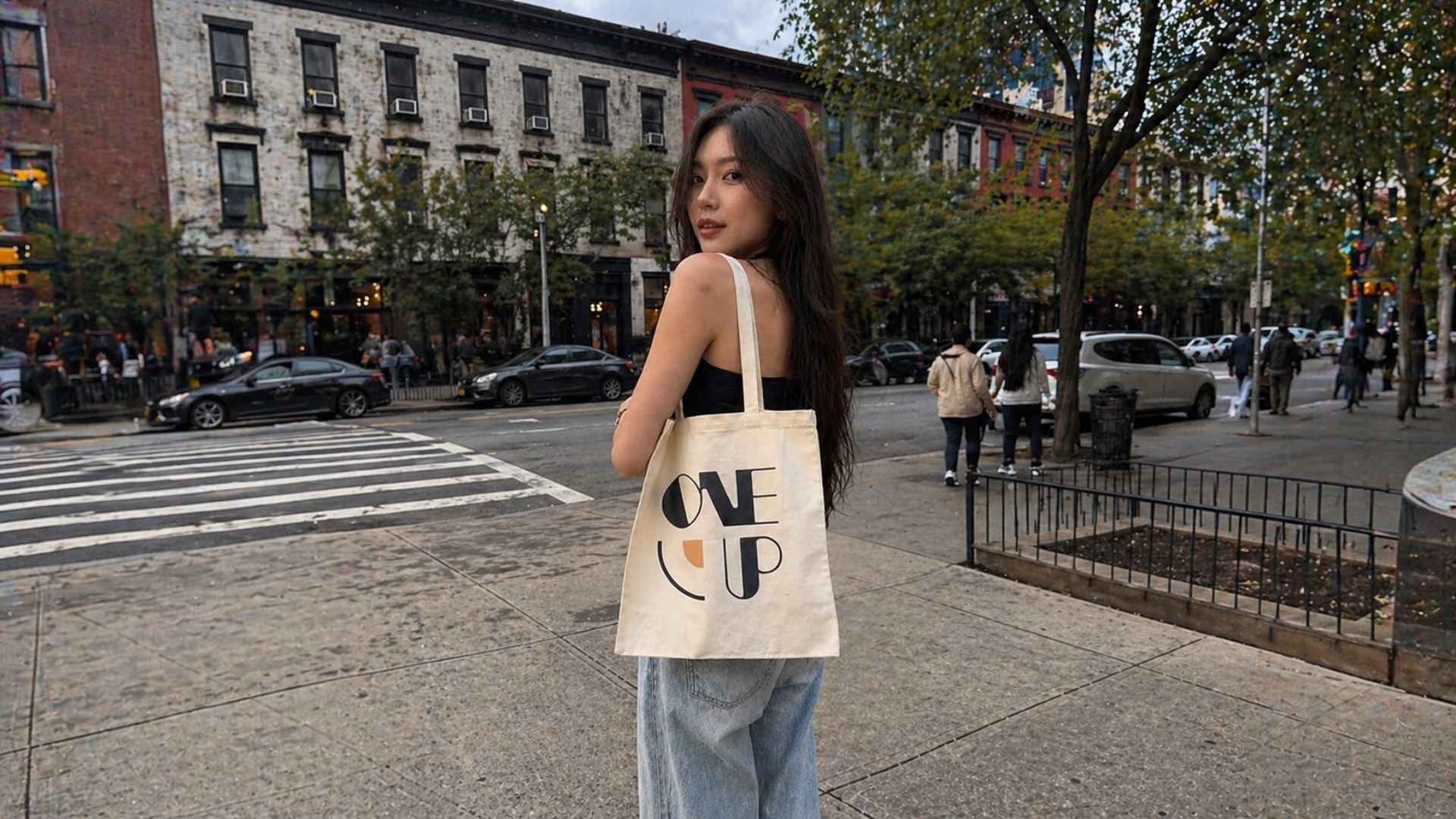 one up party tote bag woman model park with trees