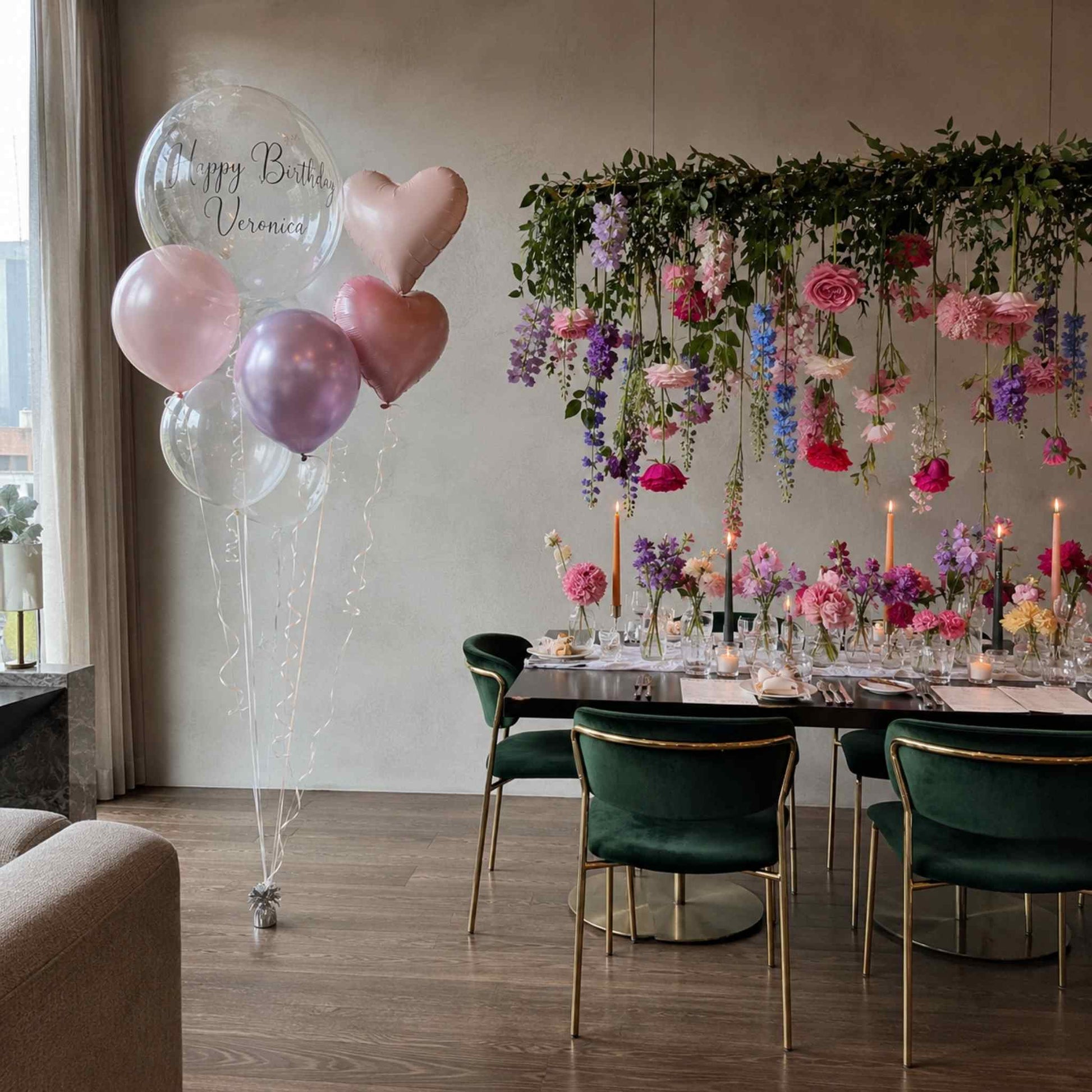 Decorated room with balloons, floral arrangements, and a table set for a celebration.