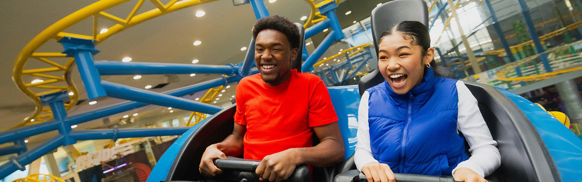 man and woman galaxy land on a ride at WEM laughing