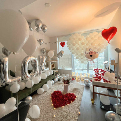 Romantic indoor setting with balloons, 'LOVE' letters, and heart-shaped decorations.