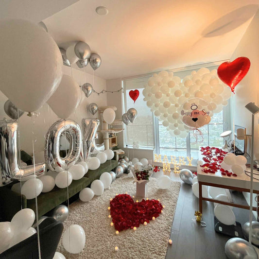 Romantic indoor setting with balloons, 'LOVE' letters, and heart-shaped decorations.