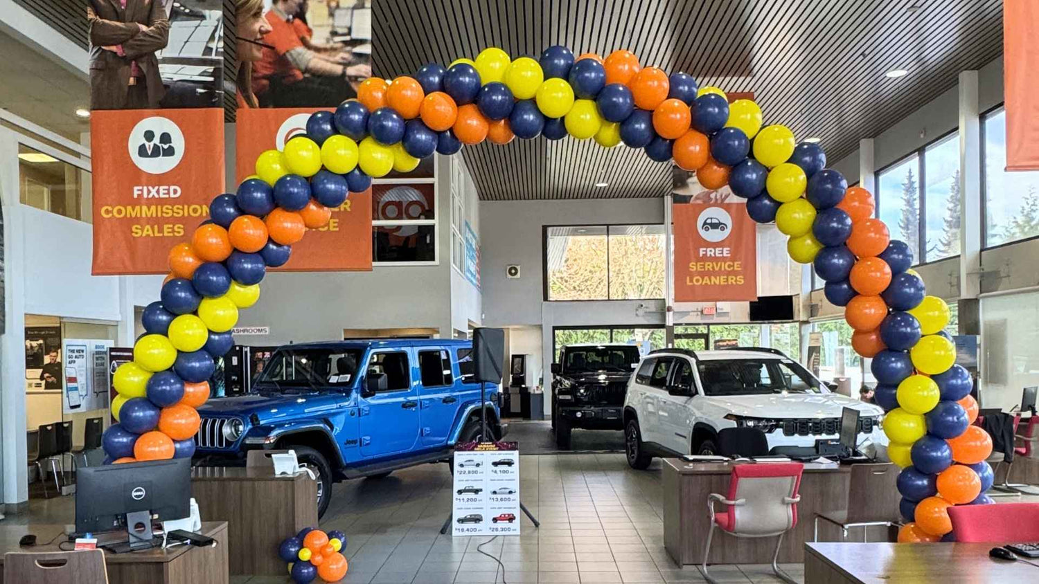 balloon arch car showroom blue yellow and orange 