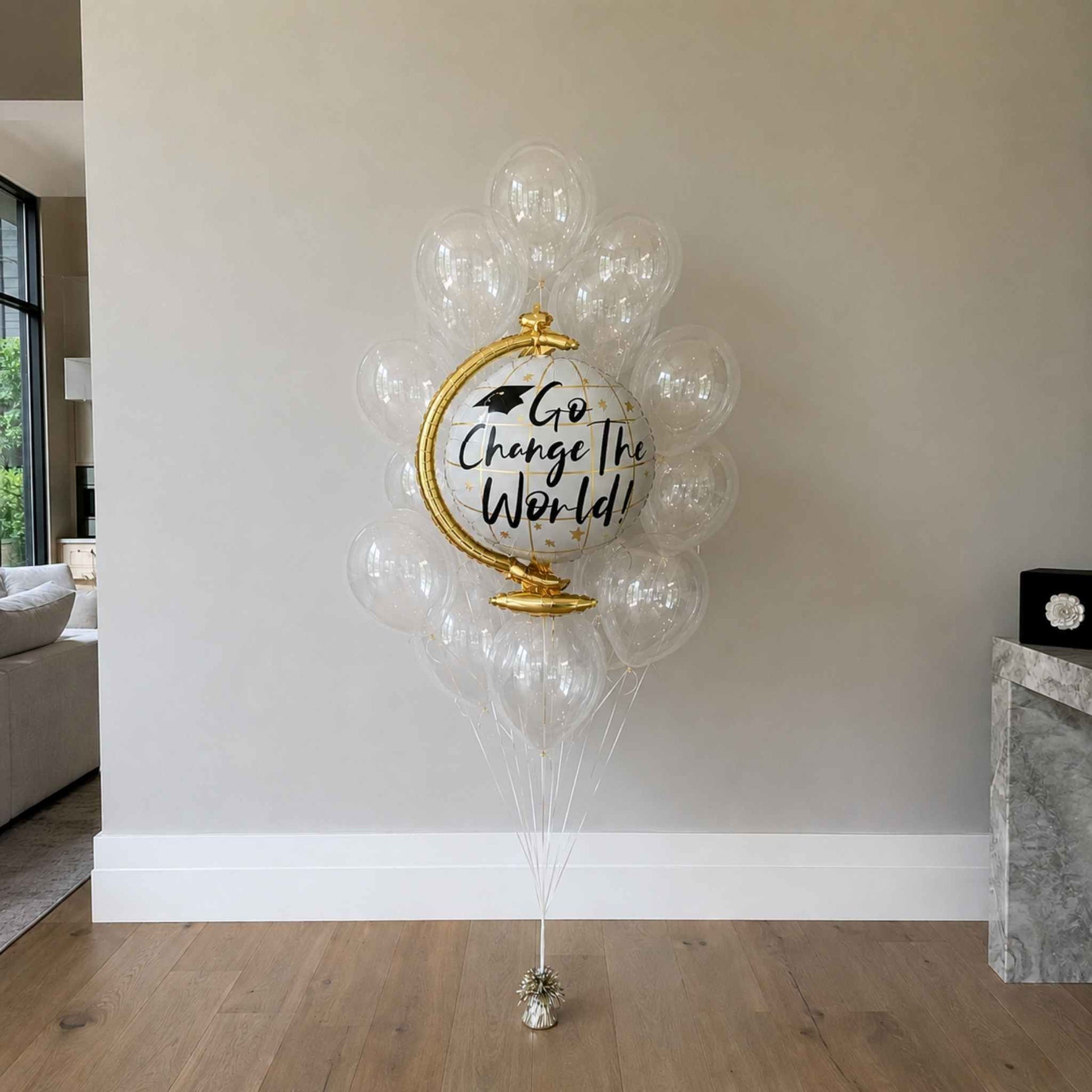 Decorative balloons with a globe and 'Go Change The World' text in a room setting.