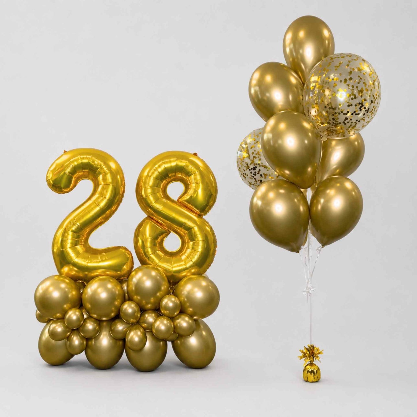 Gold foil balloon decoration set featuring a large '28' balloon number and a bunch of metallic gold and glittery gold balloons on a light gray background.