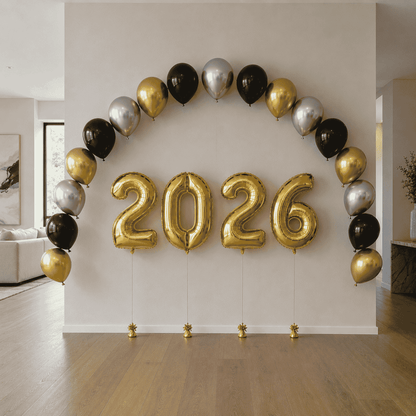 Gold, black, and silver balloons arranged in a circular pattern with '2026' in the center.