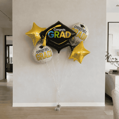 Graduation-themed balloons with 'Congrats GRAD!' text in a living room setting.